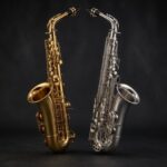 Gold and silver alto saxophones side by side on a dark backdrop